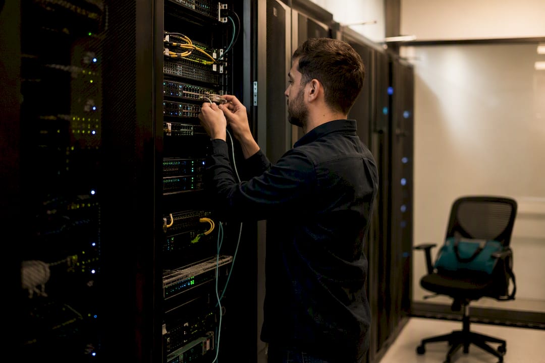Hands connecting cable in data center