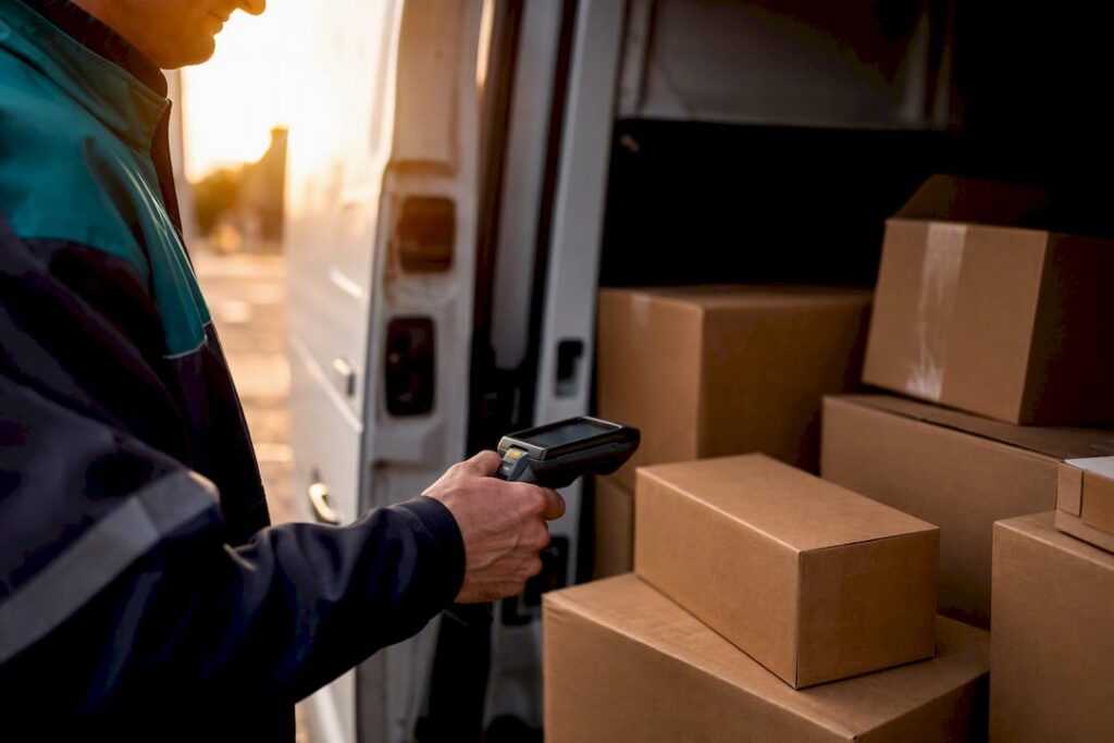 Hands scanning shipment at warehouse dock