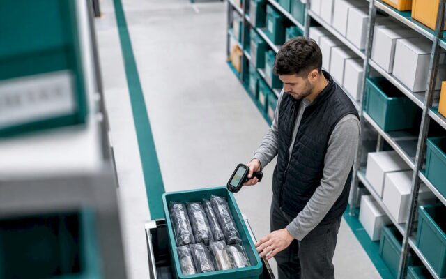 Auditor verifying warehouse inventory quantities