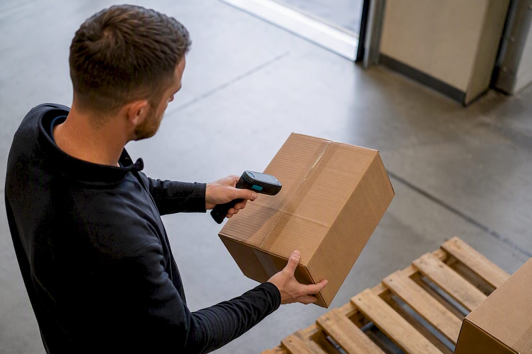 Worker verifying cartons during warehouse receiving