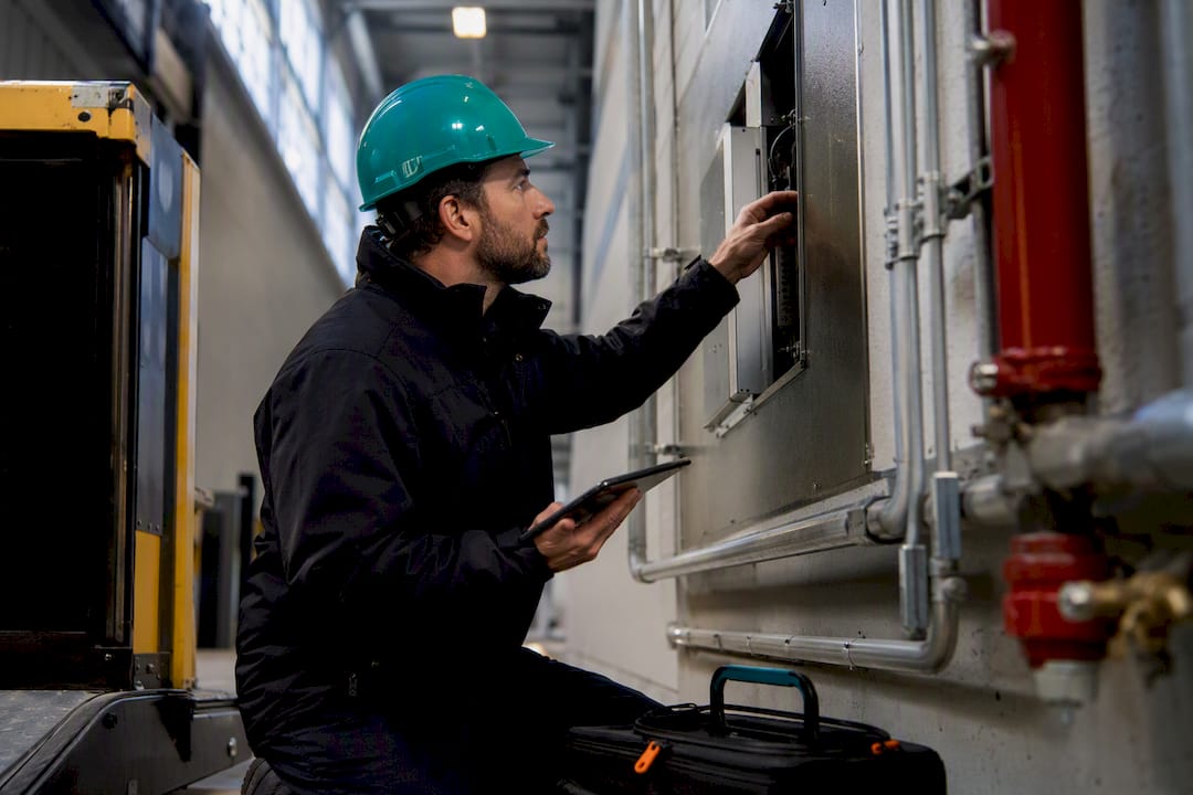 Technician inspecting newly installed warehouse systems